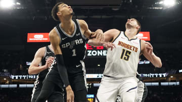 Apr 12, 2024; San Antonio, Texas, USA; Denver Nuggets center Nikola Jokic (15) and San Antonio Spurs forward Victor Wembanyama (1) box out for a rebound during the second half at Frost Bank Center. Mandatory Credit: Scott Wachter-USA TODAY Sports