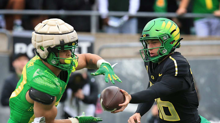 Oregon Green Team running back Jayden Limar, takes the ball from quarterback Austin Novosad during the Oregn Spring game at Autzen Stadium Saturday, April 27, 2024. Oregon Green Team running back Jayden Limar, takes the ball from quarterback Austin Novosad during the Oregn Spring game at Autzen Stadium Saturday, April 27, 2024.