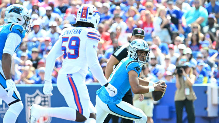 Aug 24, 2024; Orchard Park, New York, USA; Carolina Panthers quarterback Bryce Young (9) runs out of the pocket from Buffalo Bills defensive end Kingsley Jonathan (59) in the first quarter pre-season game at Highmark Stadium.