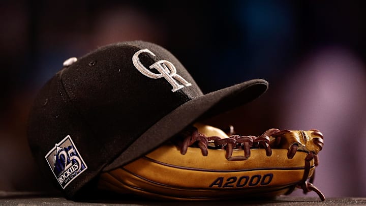 May 10, 2018; Denver, CO, USA; A detail view of a Colorado Rockies players hat and glove in the fifth inning against the Milwaukee Brewers at Coors Field. Mandatory Credit: Isaiah J. Downing-Imagn Images