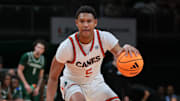 Nov 3, 2025; Coral Gables, Florida, USA; Miami Hurricanes forward Malik Reneau (5) dribbles the basketball against the Jacksonville Dolphins during the second half at Watsco Center. Mandatory Credit: Sam Navarro-Imagn Images