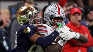 Jan 20, 2025; Atlanta, GA, USA; Ohio State Buckeyes wide receiver Jeremiah Smith (4) holds on to a catch against Notre Dame Fighting Irish cornerback Christian Gray (29) during the second half the CFP National Championship college football game at Mercedes-Benz Stadium. Mandatory Credit: Brett Davis-Imagn Images