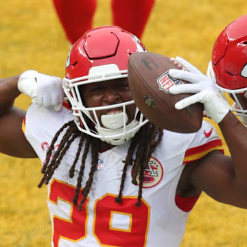 Dec 25, 2024; Pittsburgh, Pennsylvania, USA;  Kansas City Chiefs running back Kareem Hunt (29) reacts with guard Trey Smith (65) after Hunt scored a touchdown against the Pittsburgh Steelers during the fourth quarter at Acrisure Stadium. Mandatory Credit: Charles LeClaire-Imagn Images