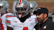 Oct 11, 2025; Champaign, Illinois, USA; Ohio State Buckeyes head coach Ryan Day talks with wide receiver Jeremiah Smith (4) during the second quarter against the Illinois Fighting Illini at Memorial Stadium. Mandatory Credit: Ron Johnson-Imagn Images