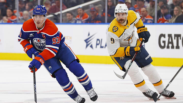 Nov 14, 2024; Edmonton, Alberta, CAN; Nashville Predators forward Filip Forsberg (9) chases Edmonton Oilers forward Ryan Nugent-Hopkins (93) up the ice during the third period at Rogers Place. Mandatory Credit: Perry Nelson-Imagn Images