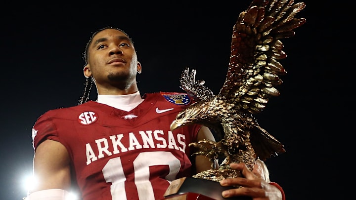 Dec 27, 2024; Memphis, TN, USA; Arkansas Razorbacks quarterback Taylen Green (10) holds the AutoZone Liberty Bowl MVP trophy after defeating against the Texas Tech Red Raiders at Simmons Bank Liberty Stadium. Mandatory Credit: Petre Thomas-Imagn Images
