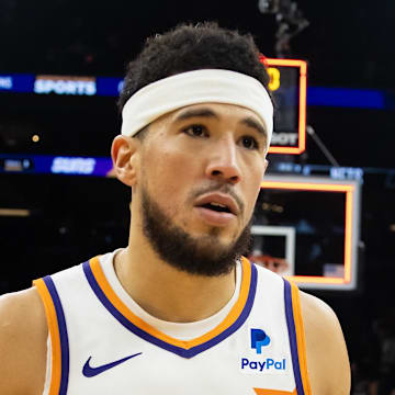 Dec 13, 2023; Phoenix, Arizona, USA; Phoenix Suns guard Devin Booker (1) reacts following the game against Brooklyn Nets at Footprint Center. Mandatory Credit: Mark J. Rebilas-Imagn Images