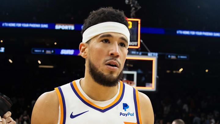 Dec 13, 2023; Phoenix, Arizona, USA; Phoenix Suns guard Devin Booker (1) reacts following the game against Brooklyn Nets at Footprint Center. Mandatory Credit: Mark J. Rebilas-Imagn Images