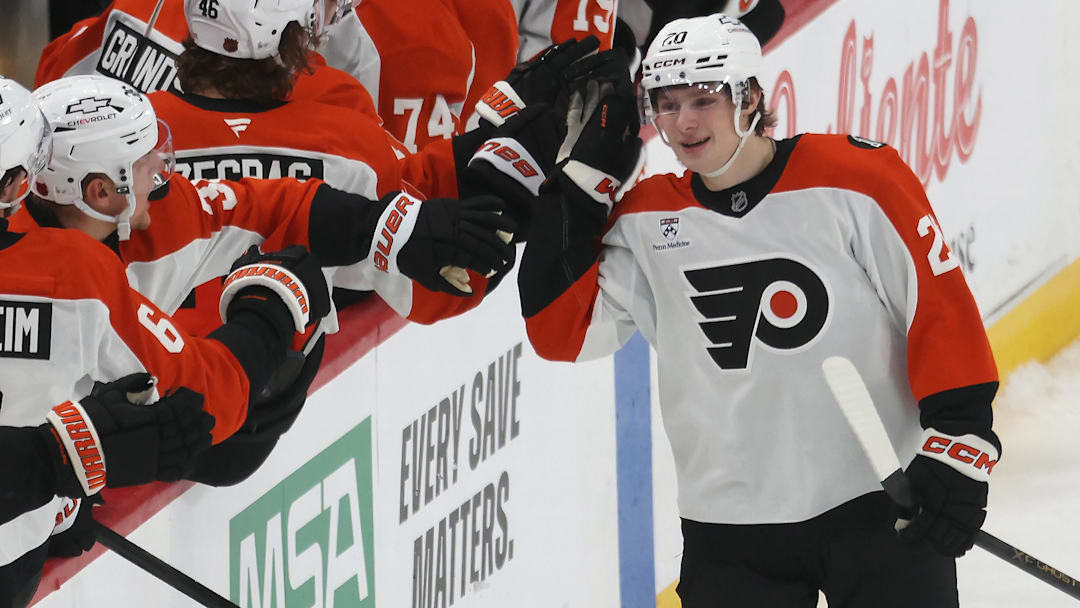 Mar 7, 2026; Pittsburgh, Pennsylvania, USA;  Philadelphia Flyers left wing Alex Bump (20) celebrates with the Flyers bench after scoring his first NHL goal in his NHL debut against the Pittsburgh Penguins during the second period at PPG Paints Arena.