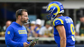 Oct 6, 2024; Inglewood, California, USA; Los Angeles Rams head coach Sean McVay talks to quarterback Matthew Stafford (9) during the third quarter against the Green Bay Packers at SoFi Stadium. Mandatory Credit: Robert Hanashiro-Imagn Images