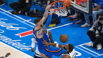 May 22, 2025; Oklahoma City, Oklahoma, USA; Oklahoma City Thunder center Isaiah Hartenstein (55) dunks against Minnesota Timberwolves center Rudy Gobert (27) in the fourth quarter during game two of the western conference finals for the 2025 NBA Playoffs at Paycom Center. Mandatory Credit: Brett Rojo-Imagn Images