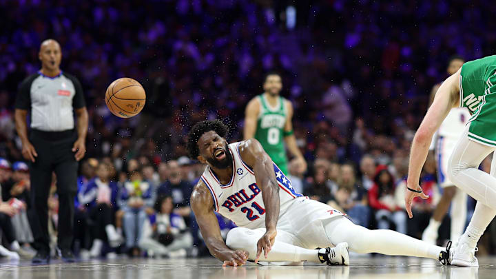Apr 30, 2026; Philadelphia, Pennsylvania, USA; Philadelphia 76ers center Joel Embiid (21) reacts after colliding with Boston Celtics forward Sam Hauser (30) on a loose ball during the first quarter at Xfinity Mobile Arena. Mandatory Credit: Bill Streicher-Imagn Images