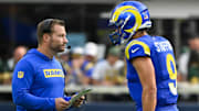 Oct 6, 2024; Inglewood, California, USA; Los Angeles Rams head coach Sean McVay talks to quarterback Matthew Stafford (9) during the third quarter against the Green Bay Packers at SoFi Stadium. Mandatory Credit: Robert Hanashiro-Imagn Images