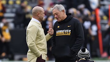 Nov 13, 2021; Iowa City, Iowa, USA; Minnesota Golden Gophers head coach P. J. Fleck (left) and Iowa Hawkeyes head coach Kirk Ferentz (right) talk before the game at Kinnick Stadium. Mandatory Credit: Jeffrey Becker-Imagn Images