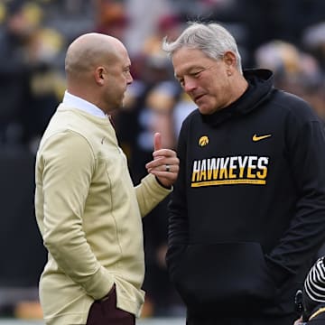 Nov 13, 2021; Iowa City, Iowa, USA; Minnesota Golden Gophers head coach P. J. Fleck (left) and Iowa Hawkeyes head coach Kirk Ferentz (right) talk before the game at Kinnick Stadium. Mandatory Credit: Jeffrey Becker-Imagn Images