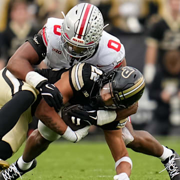 Ohio State Buckeyes linebacker Sonny Styles (0) tackles Purdue Boilermakers running back Antonio Harris (22)