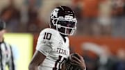 Nov 28, 2025; Austin, Texas, USA; Texas A&M Aggies quarterback Marcel Reed (10) keeps the ball for yards during the first half against the Texas Longhorns at Darrell K Royal-Texas Memorial Stadium. Mandatory Credit: Scott Wachter-Imagn Images