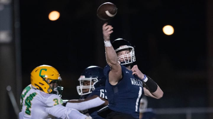 Quarterback Wells Bettenhausen (1) gets off the pass under pressure during the Catholic vs Walton high school playoff football game at Walton HIgh School in DeFuniak Springs on Friday, Nov. 17, 2023.