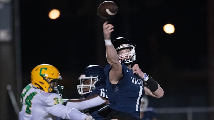 Quarterback Wells Bettenhausen (1) gets off the pass under pressure during the Catholic vs Walton high school playoff football game at Walton HIgh School in DeFuniak Springs on Friday, Nov. 17, 2023. Quarterback Wells Bettenhausen (1) gets off the pass under pressure during the Catholic vs Walton high school playoff football game at Walton HIgh School in DeFuniak Springs on Friday, Nov. 17, 2023.