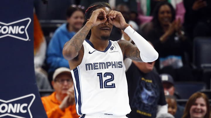 Oct 18, 2024; Memphis, Tennessee, USA; Memphis Grizzlies guard Ja Morant (12) reacts after a dunk during the first half against the Miami Heat at FedExForum. Mandatory Credit: Petre Thomas-Imagn Images