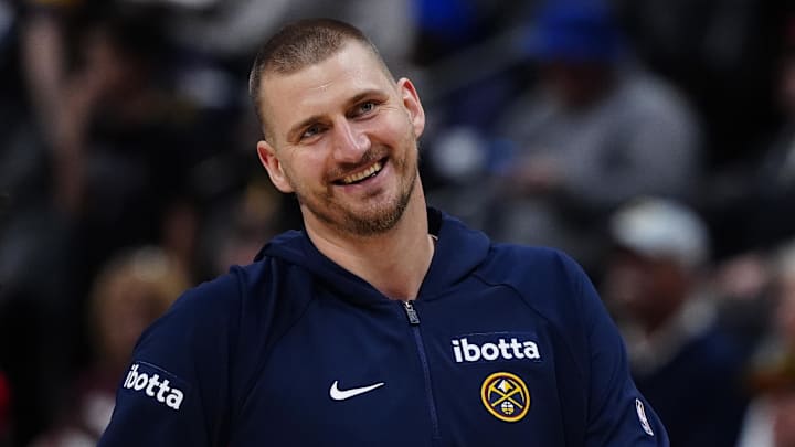 Mar 22, 2026; Denver, Colorado, USA; Denver Nuggets center Nikola Jokic (15) and guard Jamal Murray (27) react before the game against the Portland Trail Blazers at Ball Arena. Mandatory Credit: Ron Chenoy-Imagn Images