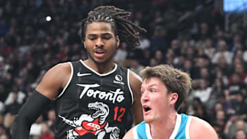 Charlotte Hornets forward Kon Knueppel controls the ball against Toronto Raptors forward Collin Murray-Boyles.