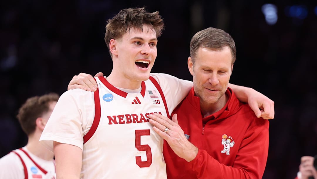 Nebraska Cornhuskers forward Braden Frager and head coach Fred Hoiberg celebrate after defeating the Troy Trojans during a first-round game of the men's 2026 NCAA Tournament at Paycom Center.