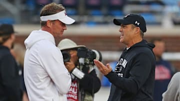 Nov 1, 2025; Oxford, Mississippi, USA; Mississippi Rebels head coach Lane Kiffin (left) talks with South Carolina Gamecocks head coach Shane Beamer during warm ups prior to the game at Vaught-Hemingway Stadium. Mandatory Credit: Petre Thomas-Imagn Images