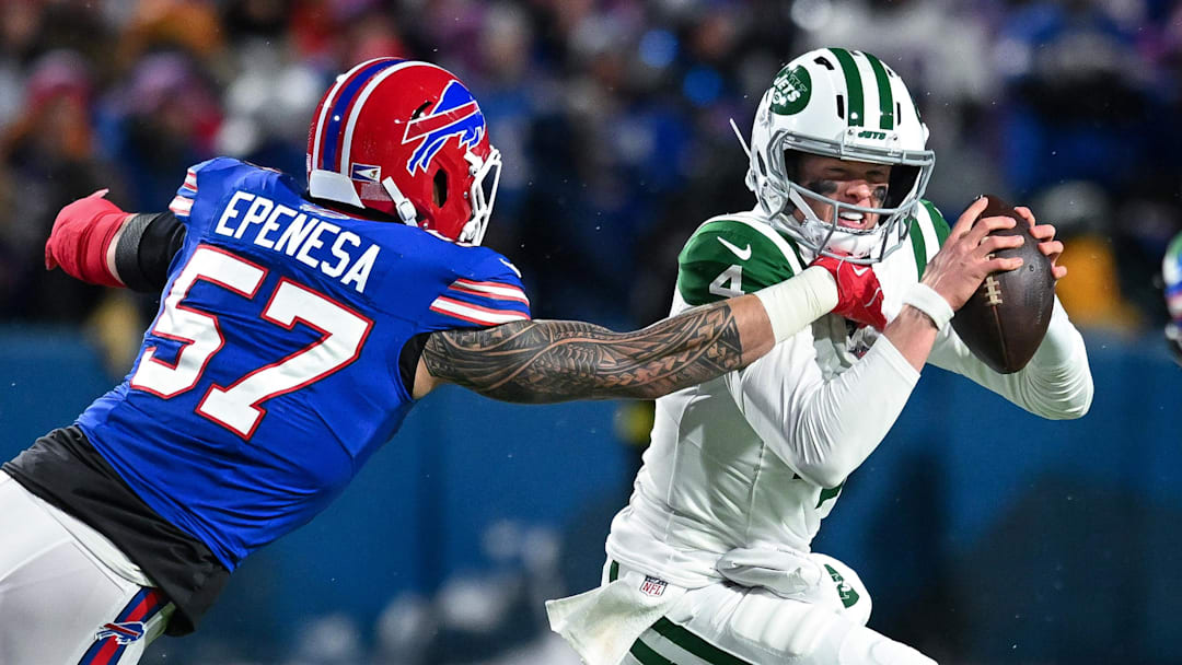 Jan 4, 2026; Orchard Park, New York, USA; New York Jets quarterback Brady Cook (4) runs from Buffalo Bills defensive end AJ Epenesa (57) in the second quarter at Highmark Stadium. Mandatory Credit: Mark Konezny-Imagn Images Jan 4, 2026; Orchard Park, New York, USA; New York Jets quarterback Brady Cook (4) runs from Buffalo Bills defensive end AJ Epenesa (57) in the second quarter at Highmark Stadium. Mandatory Credit: Mark Konezny-Imagn Images
