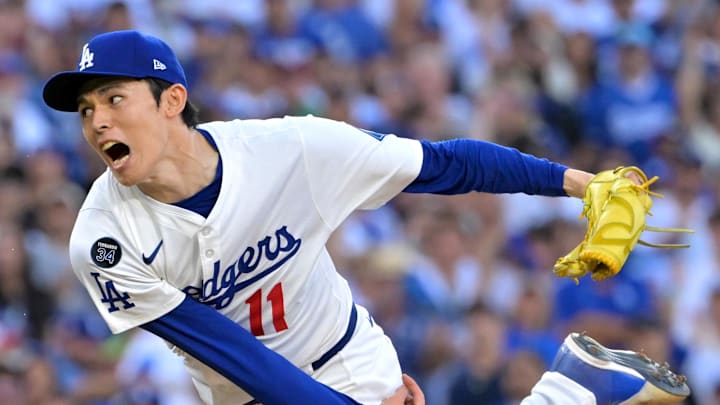 Oct 9, 2025; Los Angeles, California, USA; Los Angeles Dodgers relief pitcher Roki Sasaki (11) delivers in the eighth inning of game four of the NLDS during the 2025 MLB playoffs against the Philadelphia Phillies at Dodger Stadium.