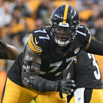 Aug 17, 2024; Pittsburgh, Pennsylvania, USA;  Pittsburgh Steelers offensive tackle Broderick Jones (77) blocks Buffalo Bills defensive tackle DeWayne Carter (90) during the first quarter at Acrisure Stadium. Mandatory Credit: Barry Reeger-Imagn Images