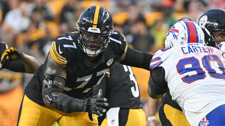 Aug 17, 2024; Pittsburgh, Pennsylvania, USA;  Pittsburgh Steelers offensive tackle Broderick Jones (77) blocks Buffalo Bills defensive tackle DeWayne Carter (90) during the first quarter at Acrisure Stadium. Mandatory Credit: Barry Reeger-Imagn Images