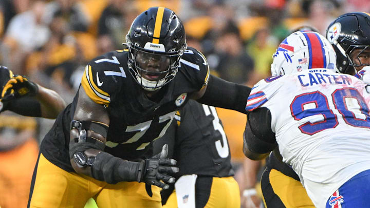 Aug 17, 2024; Pittsburgh, Pennsylvania, USA;  Pittsburgh Steelers offensive tackle Broderick Jones (77) blocks Buffalo Bills defensive tackle DeWayne Carter (90) during the first quarter at Acrisure Stadium. Mandatory Credit: Barry Reeger-Imagn Images