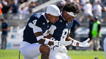 Penn State defensive players on their knees