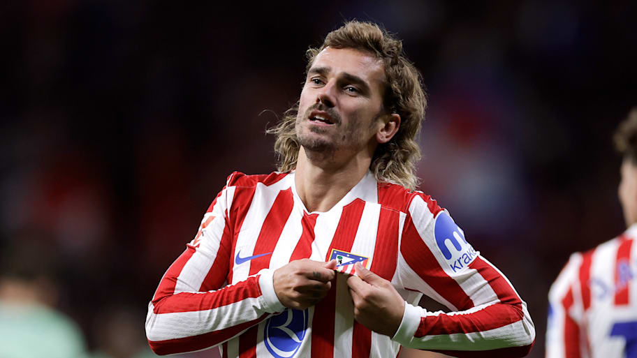 Antoine Griezmann kissing the badge.