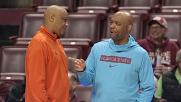Feb 19, 2025; Tallahassee, Florida, USA; Miami Hurricanes interim head coach Bill Courtney chats with Florida State Seminoles head coach Leonard Hamilton during pregame at Donald L. Tucker Center. Mandatory Credit: Melina Myers-Imagn Images