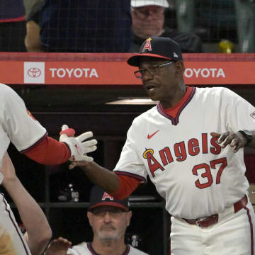 Jul 30, 2024; Anaheim, California, USA; Los Angeles Angels left fielder Taylor Ward (3) is greeted at the dugout by manager Ron Washington (37) after scoring on a single by catcher Matt Thaiss (21) in the fourth inning at Angel Stadium. Mandatory Credit: Jayne Kamin-Oncea-USA TODAY Sports