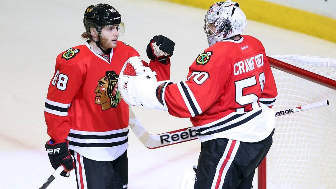 May 18, 2014; Chicago, IL, USA; Chicago Blackhawks right wing Patrick Kane (88) celebrates with goalie Corey Crawford (50) after game one of the Western Conference Final of the 2014 Stanley Cup Playoffs against the Los Angeles Kings at United Center. Mandatory Credit: Jerry Lai-USA TODAY Sports