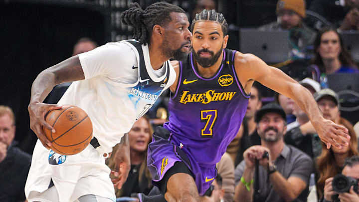 Minnesota Timberwolves center Naz Reid (11) dribbles against the Los Angeles Lakers guard Gabe Vincent (7) in the second quarter at Target Center.