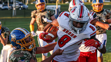 Bryan Mitzel (2) pulls down Lex Cyrus (8) along the near sideline. The Northern Lebanon Vikings played host to the Susquehanna Twp. Indians Friday September 1, 2023. The Indians defeated the Vikings 42-14.
