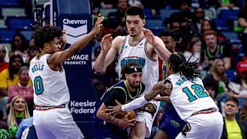 Mar 9, 2025; New Orleans, Louisiana, USA;  New Orleans Pelicans guard Jose Alvarado (15) fights for position against Memphis Grizzlies guard Ja Morant (12) and forward Jaylen Wells (0) and center Zach Edey (14) during the second half at Smoothie King Center. Mandatory Credit: Stephen Lew-Imagn Images