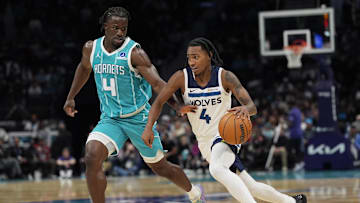 Rob Dillingham of the Timberwolves driving past a Hornets defender.