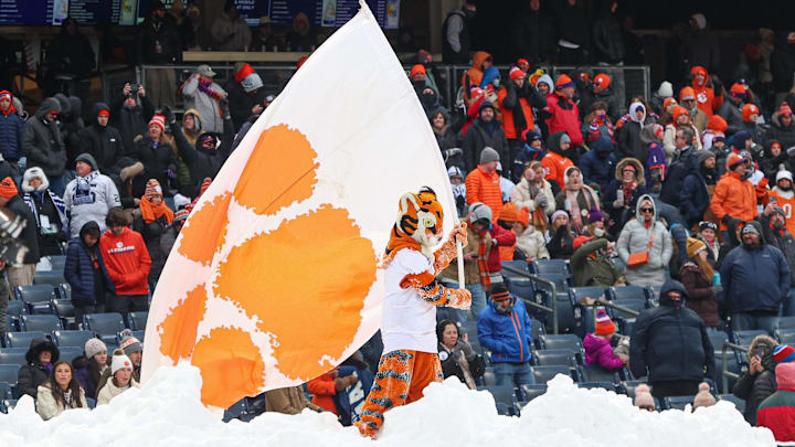Dec 27, 2025; Bronx, NY, USA; The Clemson Tiger waves a flag while standing on a snow pile during the second half of the 2025 Pinstripe Bowl against the Penn State Nittany Lions at Yankee Stadium. Mandatory Credit: Vincent Carchietta-Imagn Images