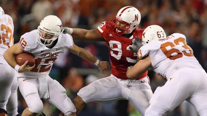 Dec 5, 2009; Arlington, TX, USA; Texas Longhorns quarterback Colt McCoy (12) scrambles to get away from a sack by Nebraska Cornhuskers defensive tackle Ndamukong Suh (93) during the Big 12 championship game at Cowboys Stadium. The Longhorns beat the Cornhuskers 13-12.