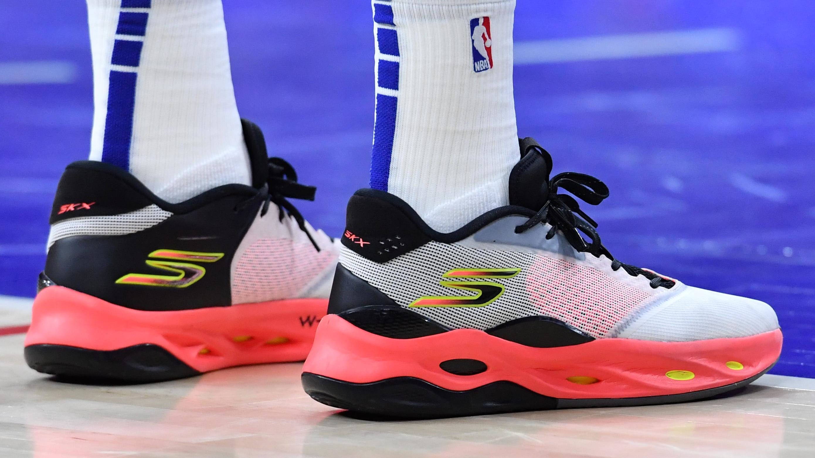 Philadelphia 76ers center Joel Embiid's black and orange Skechers sneakers.