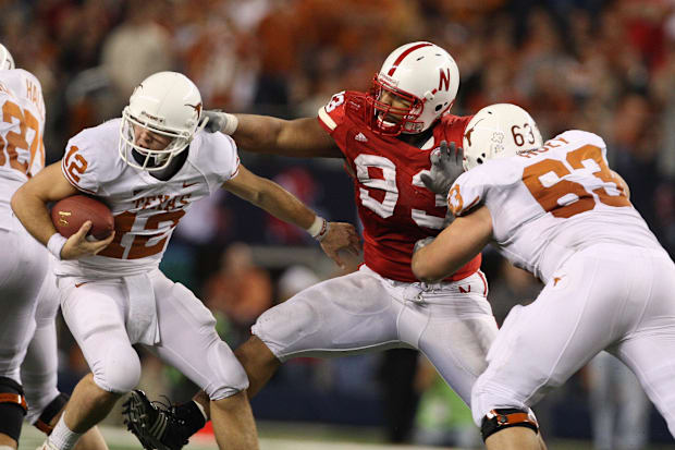 Texas Longhorns quarterback Colt McCoy scrambles to get away from a sack by Nebraska Cornhusker Ndamukong Suh