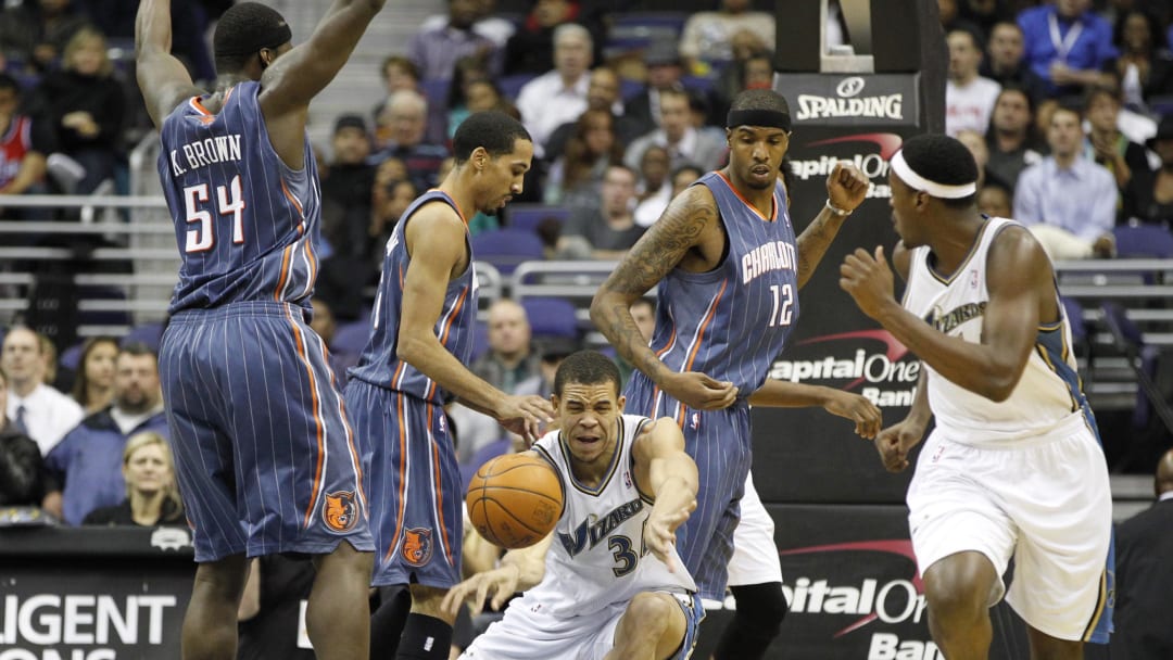 December 20, 2010; Washington, DC, USA; Washington Wizards center JaVale McGee (34) passes the ball around Charlotte Bobcats center Kwame Brown (54) in the first half at Verizon Center. The Wizards won 108-75. Mandatory Credit: Geoff Burke-USA TODAY Sports