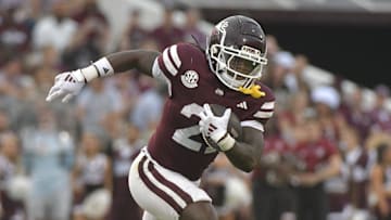 Nov 2, 2024; Starkville, Mississippi, USA; Mississippi State Bulldogs running back Davon Booth (21) runs the ball against the Massachusetts Minutemen during the third quarter at Davis Wade Stadium at Scott Field. Mandatory Credit: Matt Bush-Imagn Images