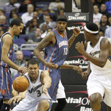 December 20, 2010; Washington, DC, USA; Washington Wizards center JaVale McGee (34) passes the ball around Charlotte Bobcats center Kwame Brown (54) in the first half at Verizon Center. The Wizards won 108-75. Mandatory Credit: Geoff Burke-USA TODAY Sports