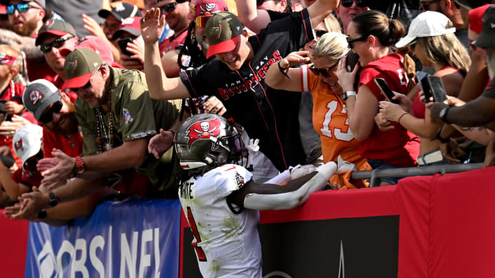 Nov 12, 2023; Tampa, Florida, USA; Tampa Bay Buccaneers running back Rachaad White (1) celebrates with some fans after scoring a touchdown the first half against the Tennessee Titans at Raymond James Stadium. Mandatory Credit: Jonathan Dyer-USA TODAY Sports